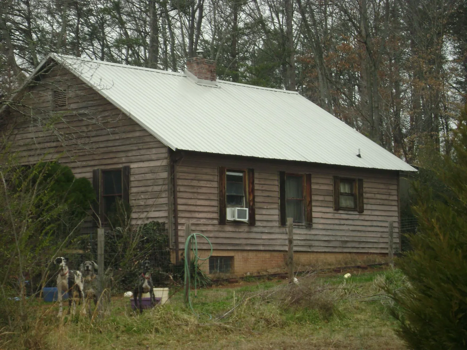 White metal roof on an old wood sided farmhouse, from a Metal Roof Installation job in Custar